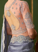 Metallic steel lavender saree with peach blouse and gold lace embroidery on bodice