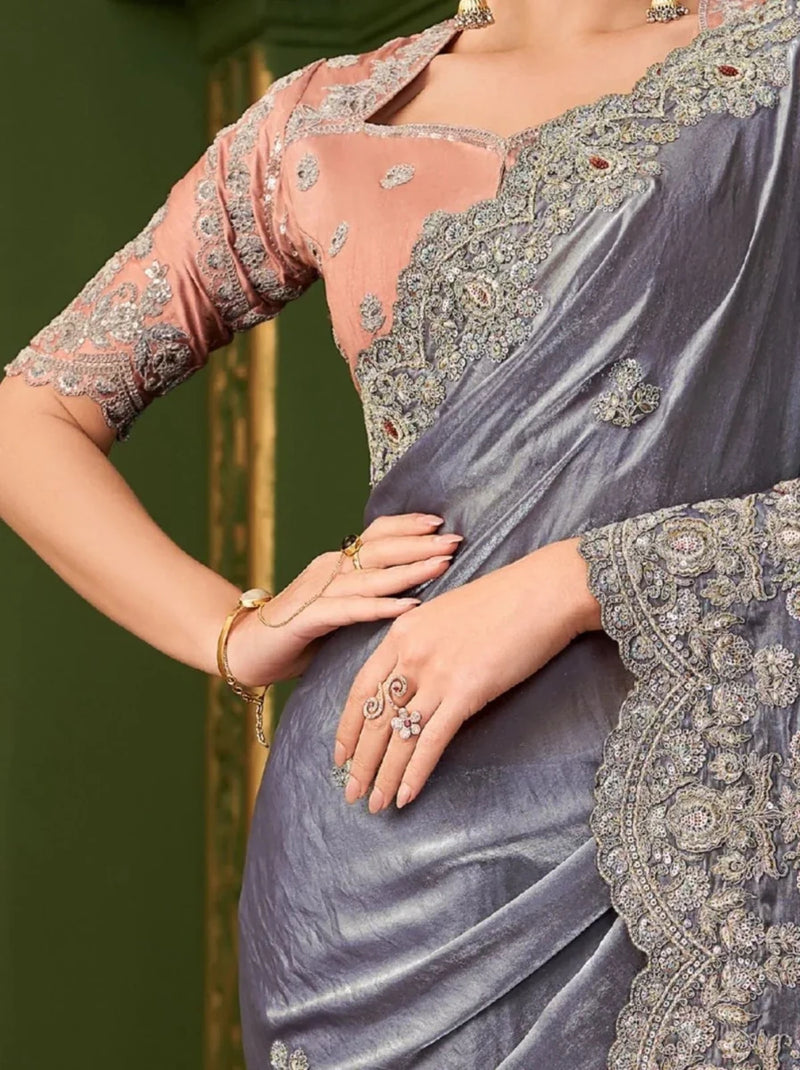 Metallic steel lavender saree with ornate gold embroidery and peach blouse sleeves