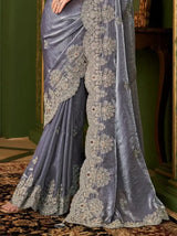 Metallic steel lavender saree with ornate gold border embroidery, flowing pleats