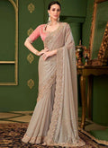 Metallic taupe georgette saree with blush pink embroidered blouse, draped with pallu