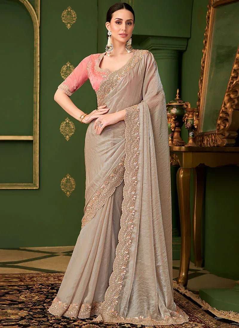 Metallic taupe georgette saree with blush pink embroidered blouse, draped with pallu