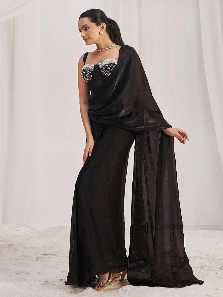 Corset-ready black saree with pearl-beaded neckline and sheer pallu over shoulder