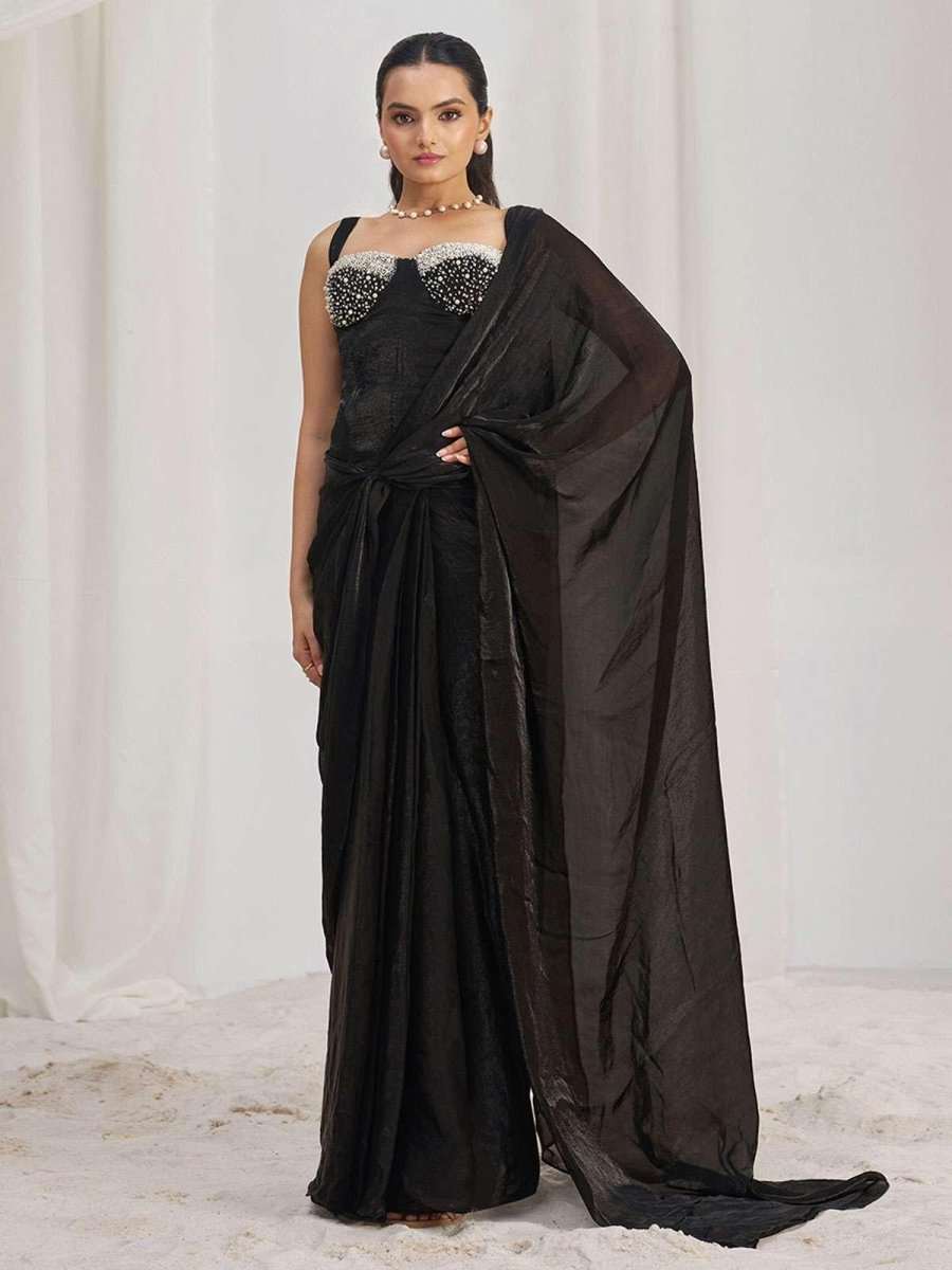 Corset-ready black saree with jeweled bodice and flowing sheer pallu at side