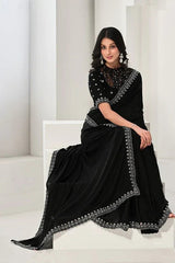 Black satin silk saree with silver sequined border, worn with head covering