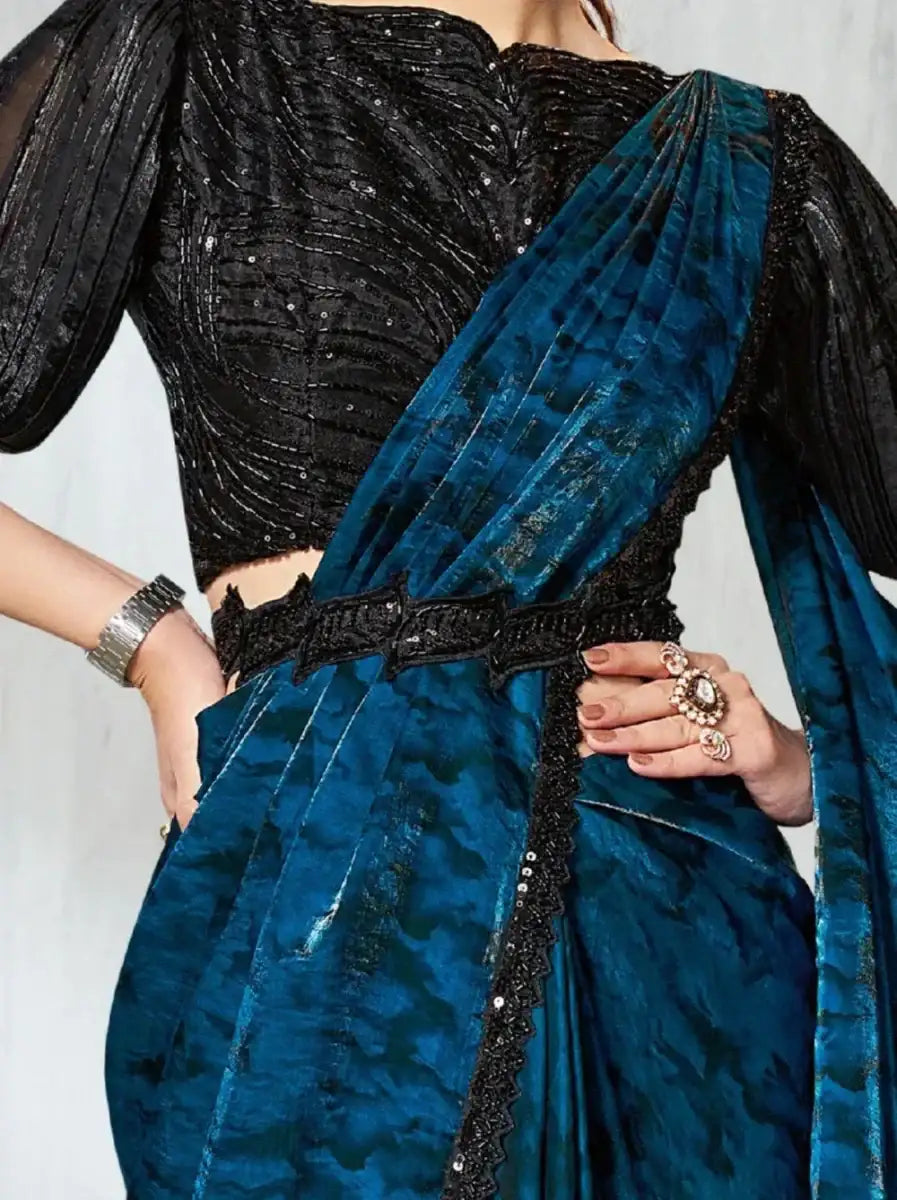 Teal satin saree with black sequined blouse, embellished waist belt and border