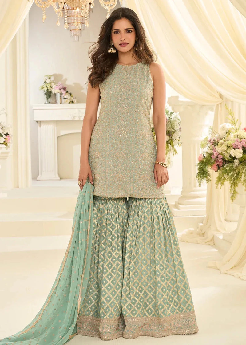 Mint green sleeveless gharara suit with allover embroidery and flared kurta hem