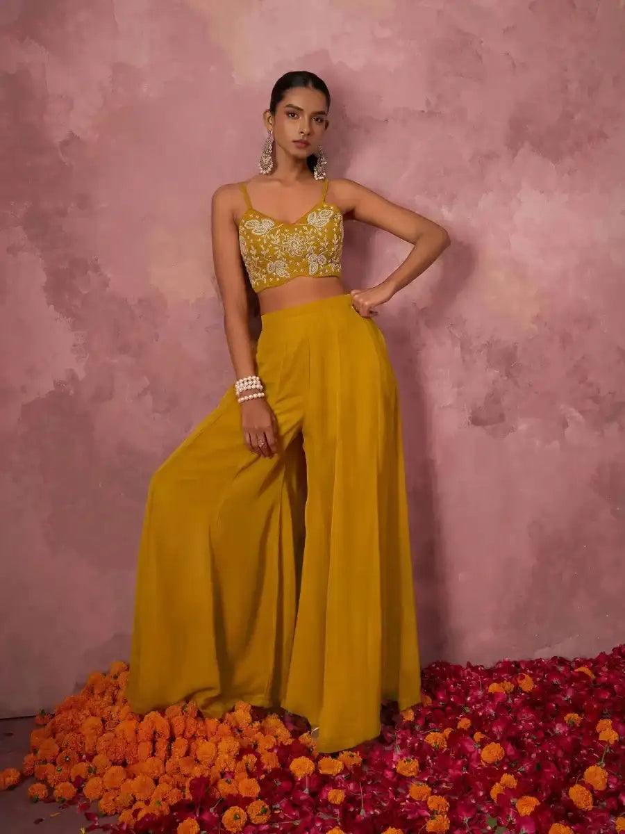 Mustard yellow sharara set with embroidered bralette and flowing wide-leg pants