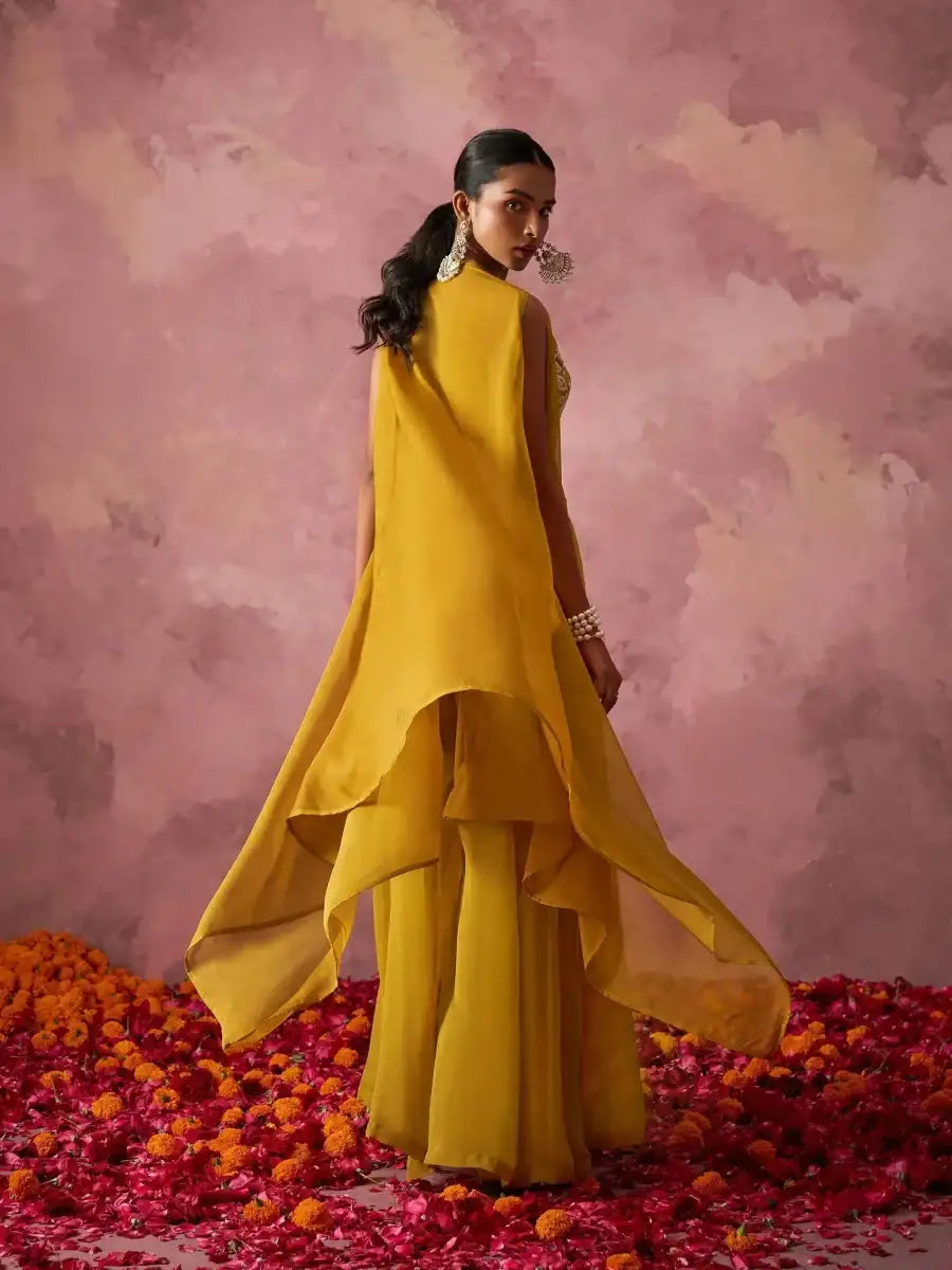 Mustard yellow sharara set with sleeveless embroidered bralette and organza cape