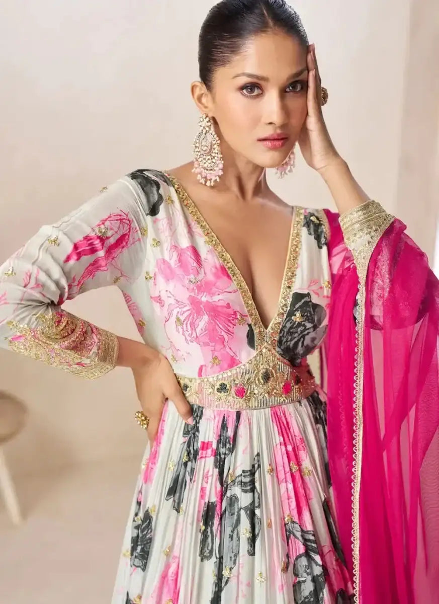 Off-white floral gown with gold waist trim and pink dupatta over shoulder