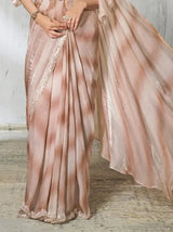 Rose gold metallic saree skirt with vertical pleats and decorative hem border.