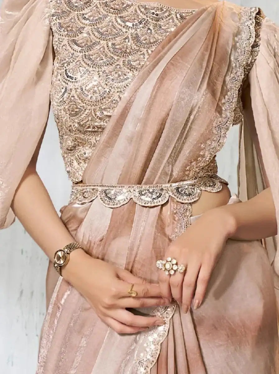 Rose gold metallic saree detail: ornate neckline, belt, and shimmering fabric drape