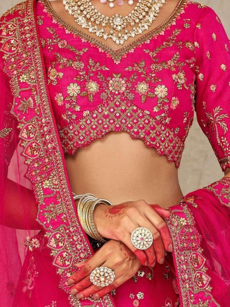 Rani pink embroidered blouse with V neckline, gold floral motifs, and sheer sleeve edge