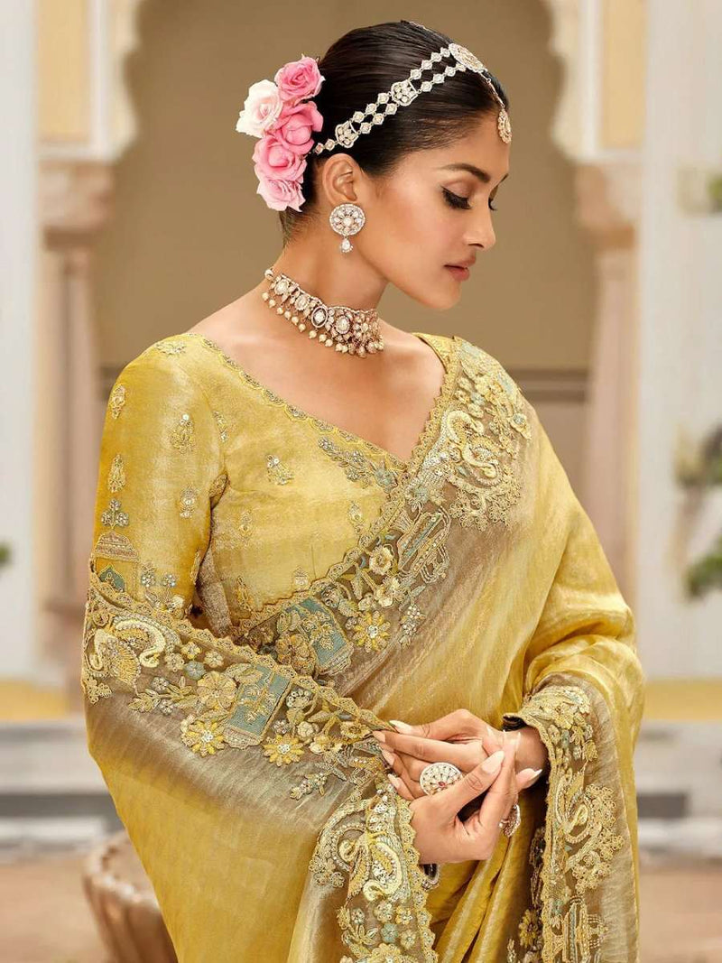 Royal yellow soft silk saree with gold embroidery, paisley motifs, and pleated pallu