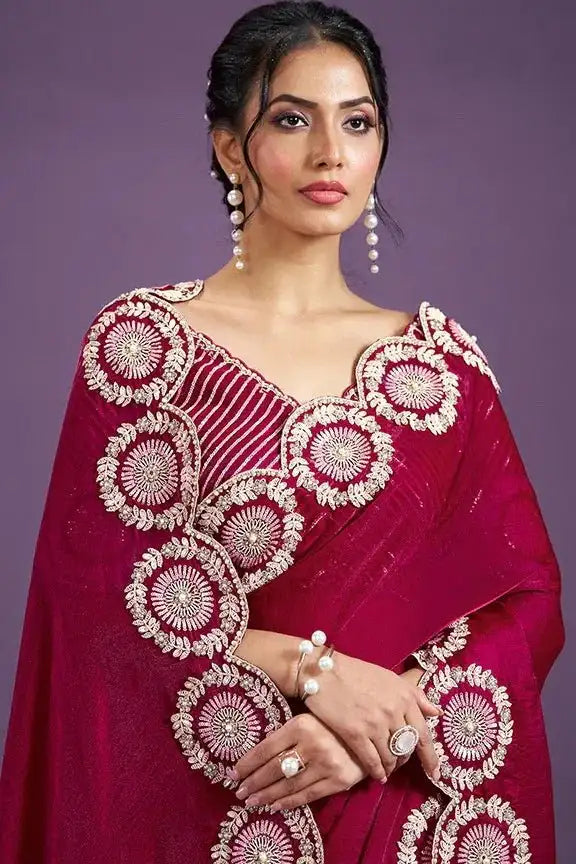 Ruby pink saree with wide circular embroidery on the pallu and blouse sleeves