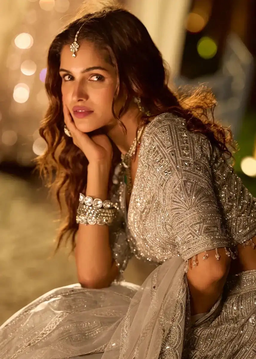 Silver metallic lehenga with mirror-work sleeves, scalloped neckline, and embellished skirt