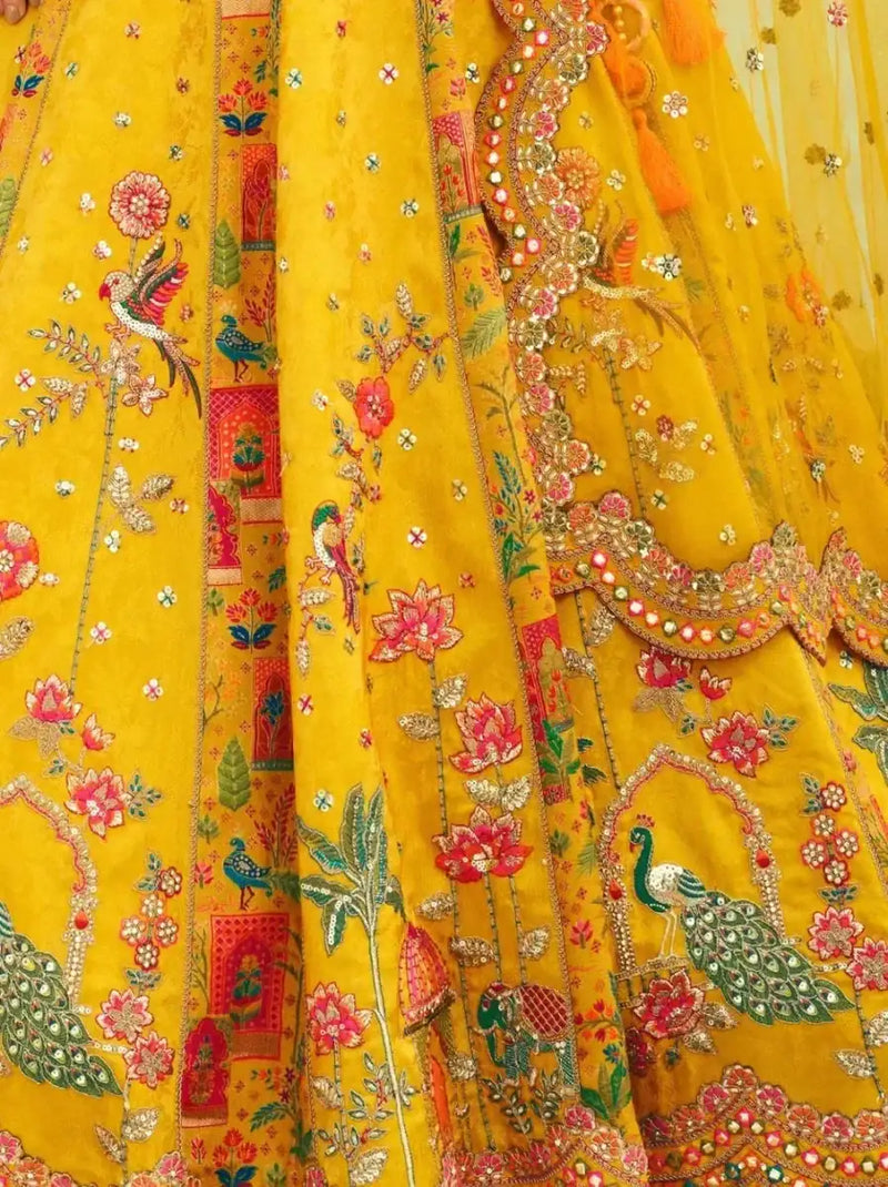 Yellow floral lehenga fabric detail with colorful thread and mirror accents