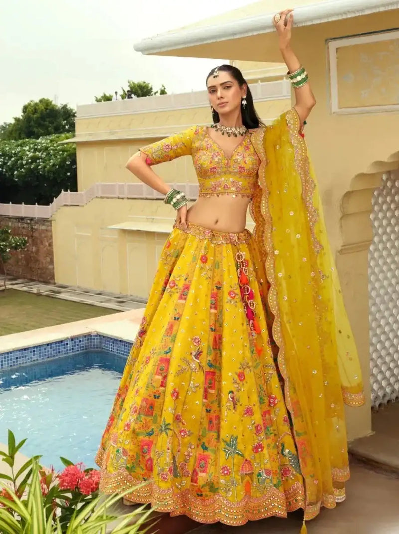 Yellow floral lehenga ensemble with matching blouse and sheer dupatta