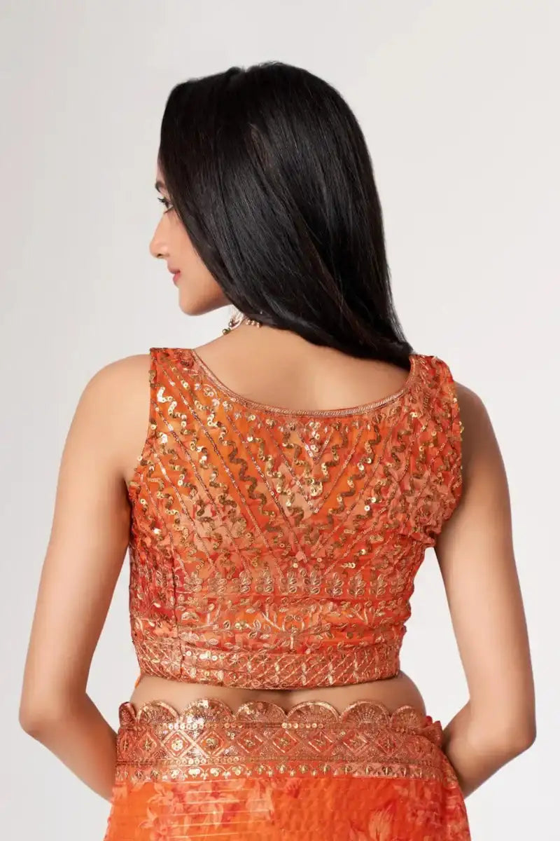 Back view of orange sequin saree with scalloped lace-like neckline detail
