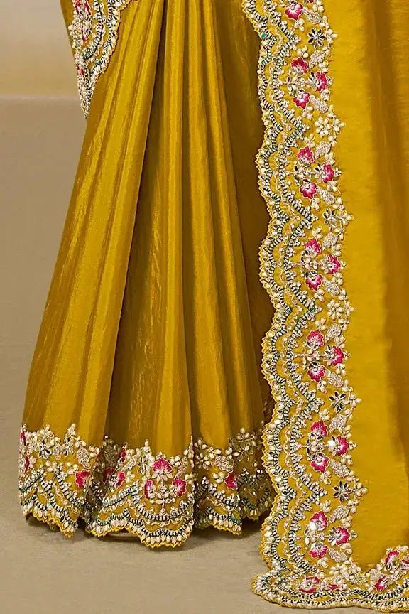Yellow saree with scalloped embroidered hem and floral border