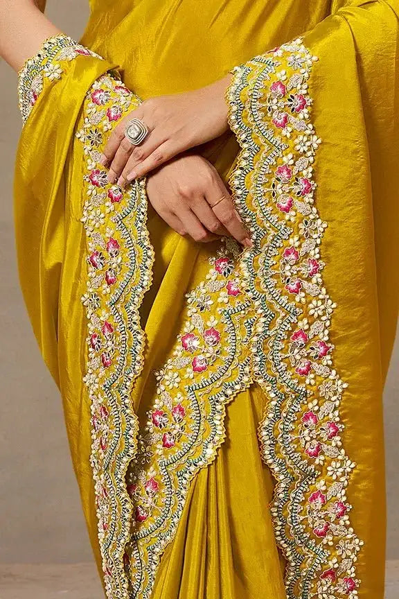 Yellow saree with wide scalloped embroidered border and multicolor floral motifs