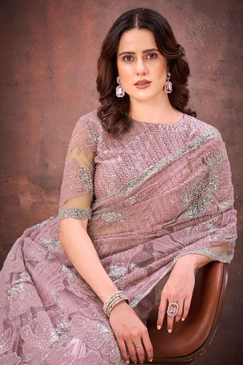 Light pink net saree with sequined patterns and three-quarter stitched blouse sleeves