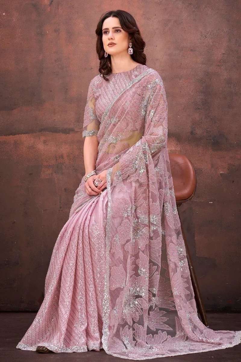 Light pink net saree with floral applique motifs and matching stitched blouse