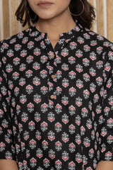 Black floral tunic front detail with button placket and small patterned motifs