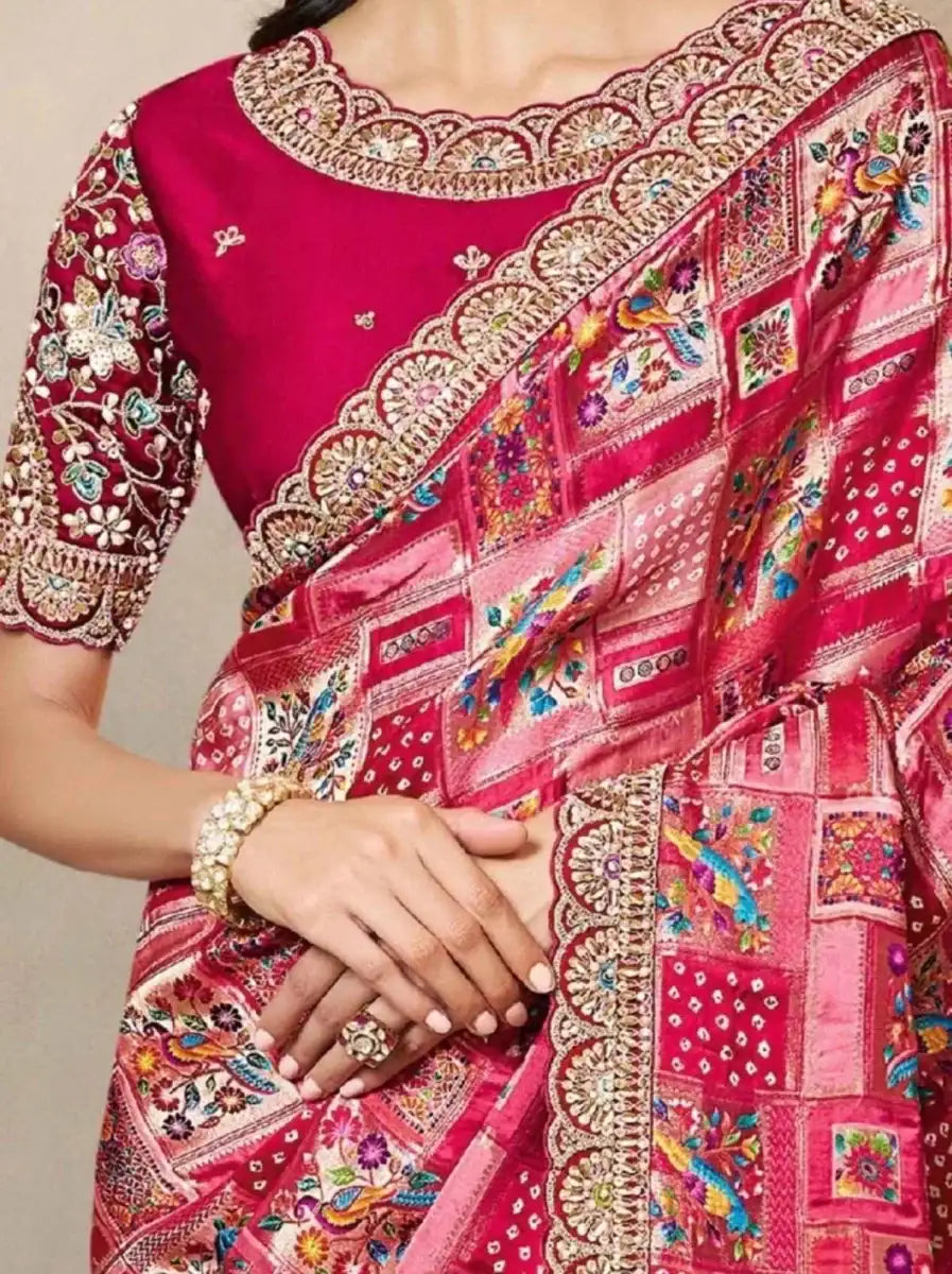 Magenta silk saree pallu detail with gold border and multicolor motifs