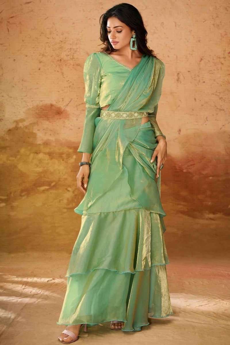 Mint green organza western saree with long tiered skirt, V-neck, and gold trim