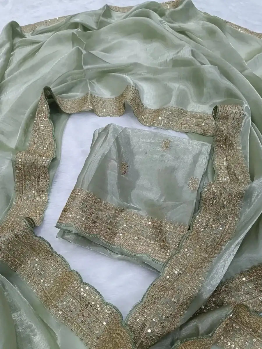 Mint green silk saree with gold sequin lace border and folded blouse piece