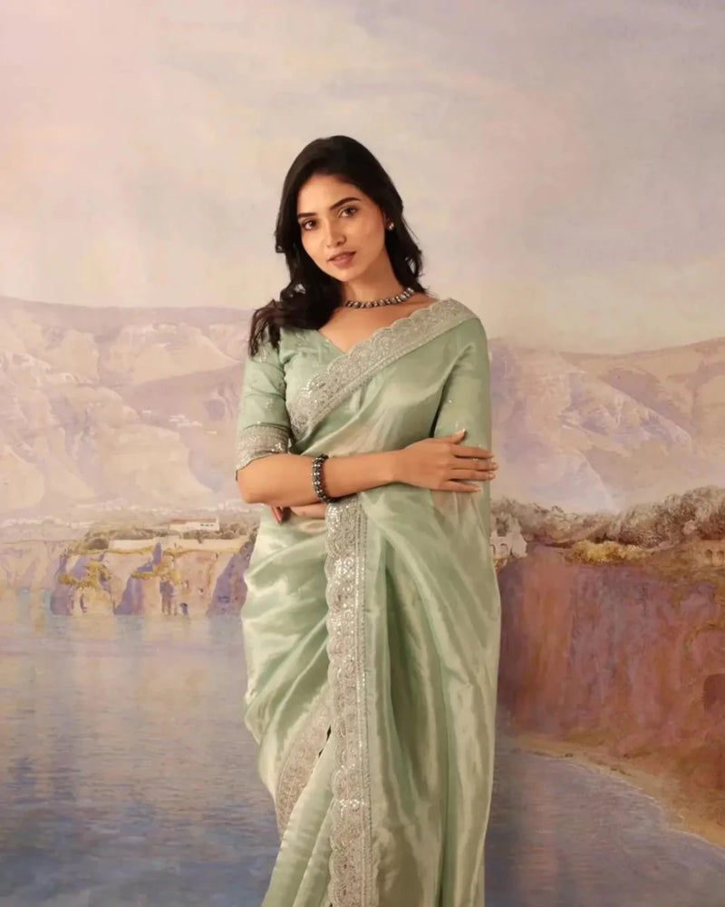 Mint green silk saree with gold sequin lace border and elbow-length sleeve blouse