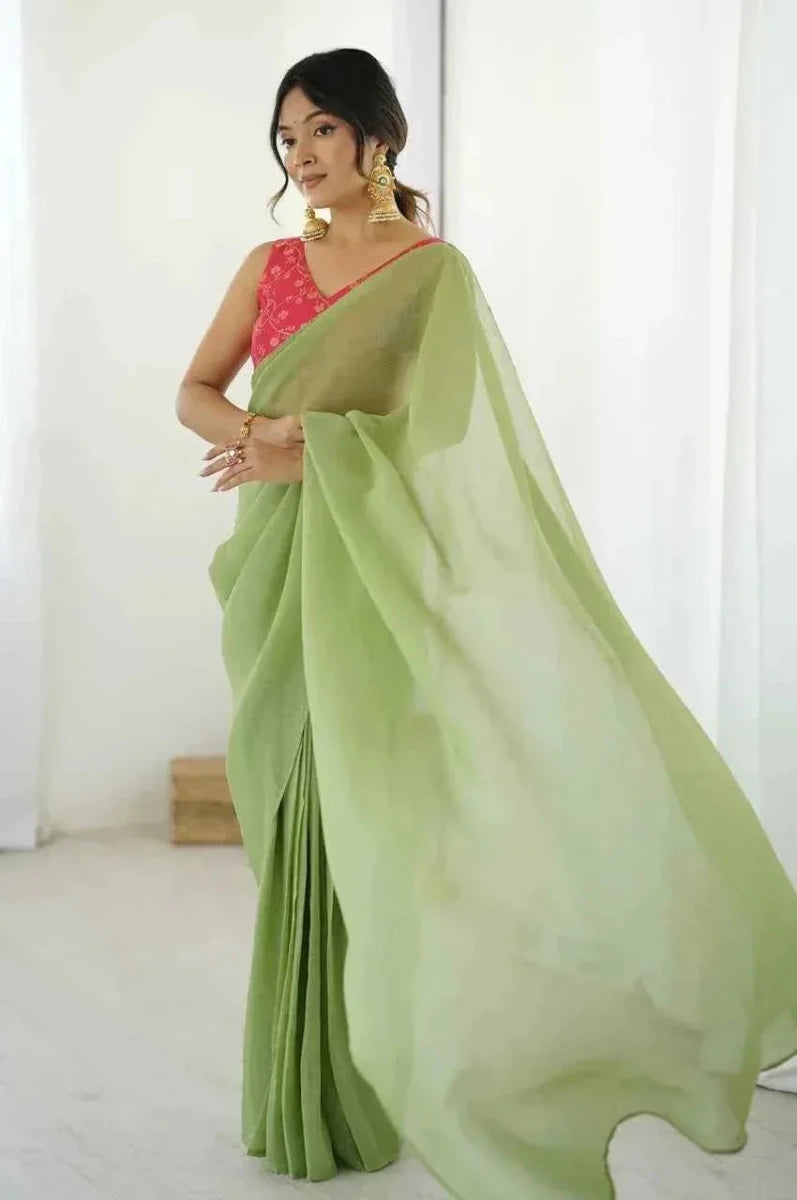 Light green silk saree with red blouse, wide pallu flowing