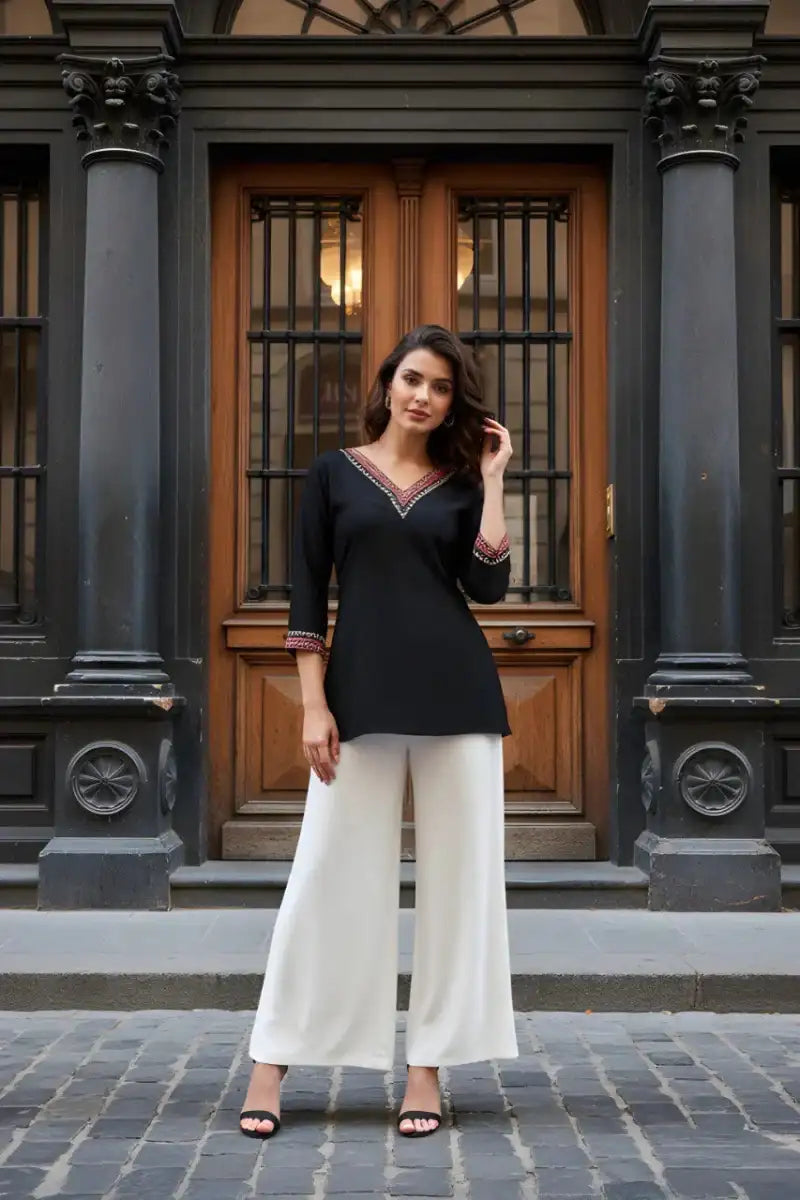 Black V-neck tunic with embroidered neckline and cuffs, long sleeves