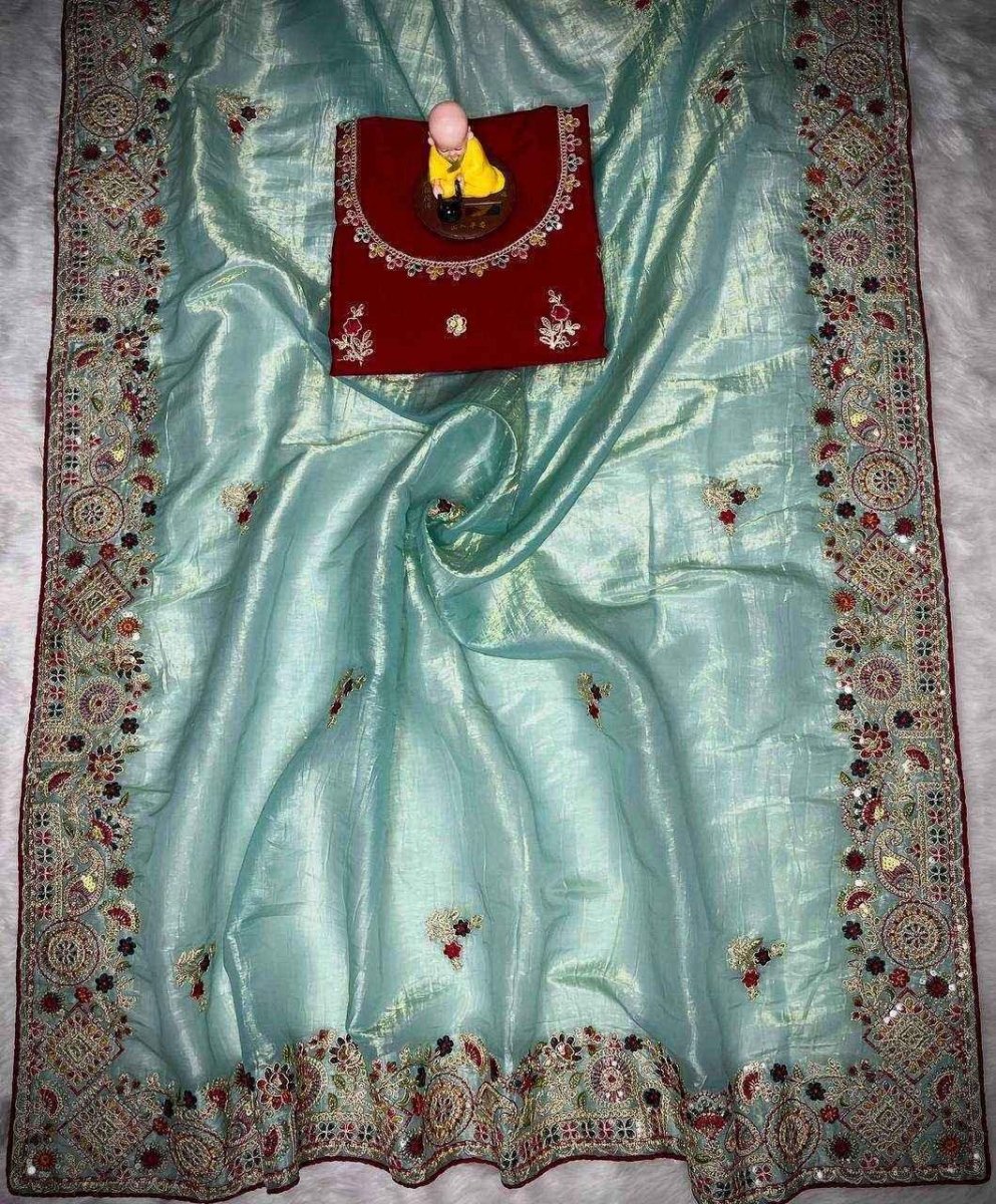 Aqua blue saree with multicolor embroidered border and scattered decorative motifs