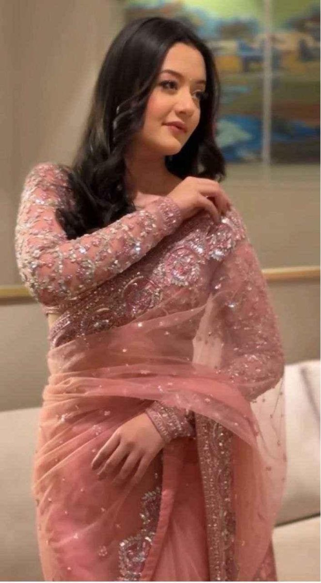 Peach-pink net saree with floral zari embroidery and sequins, draped on model