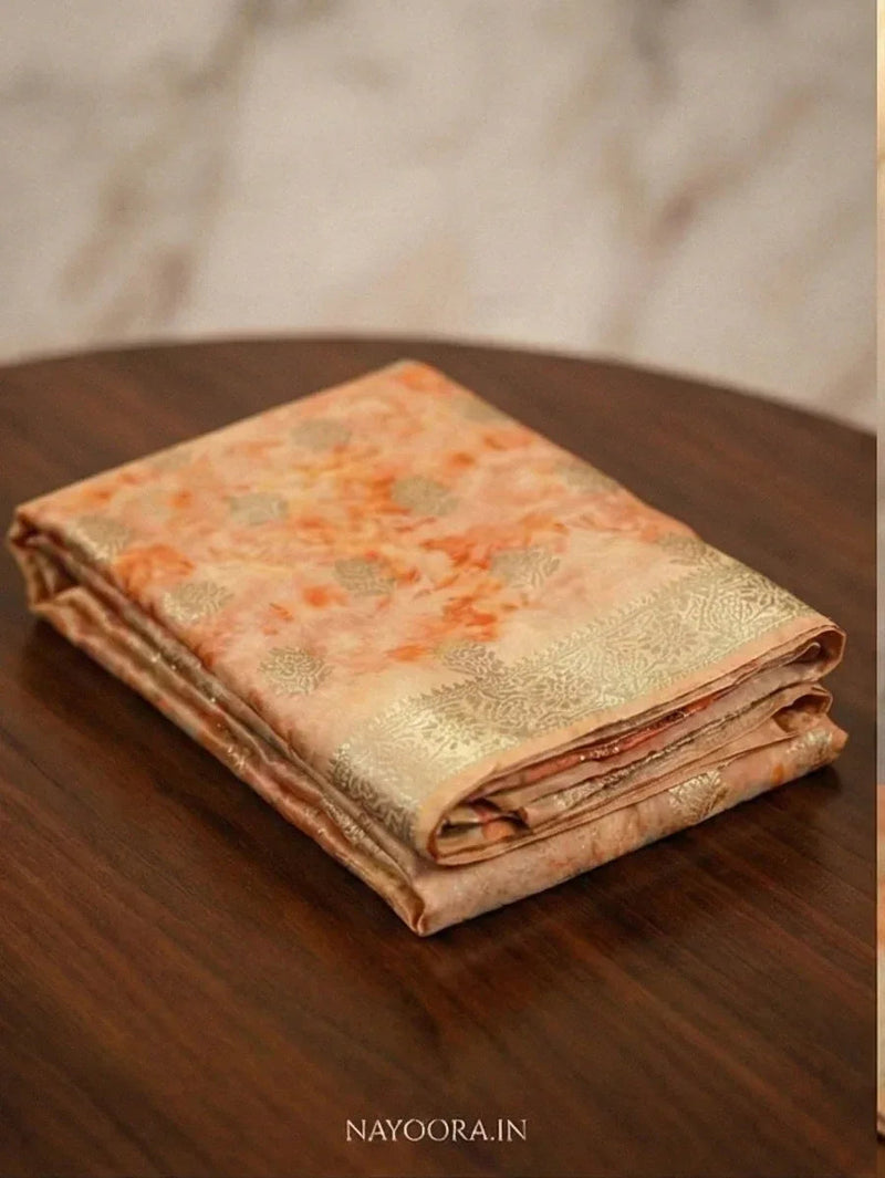 Peach shibori printed silk saree folded stack with wide gold zari border