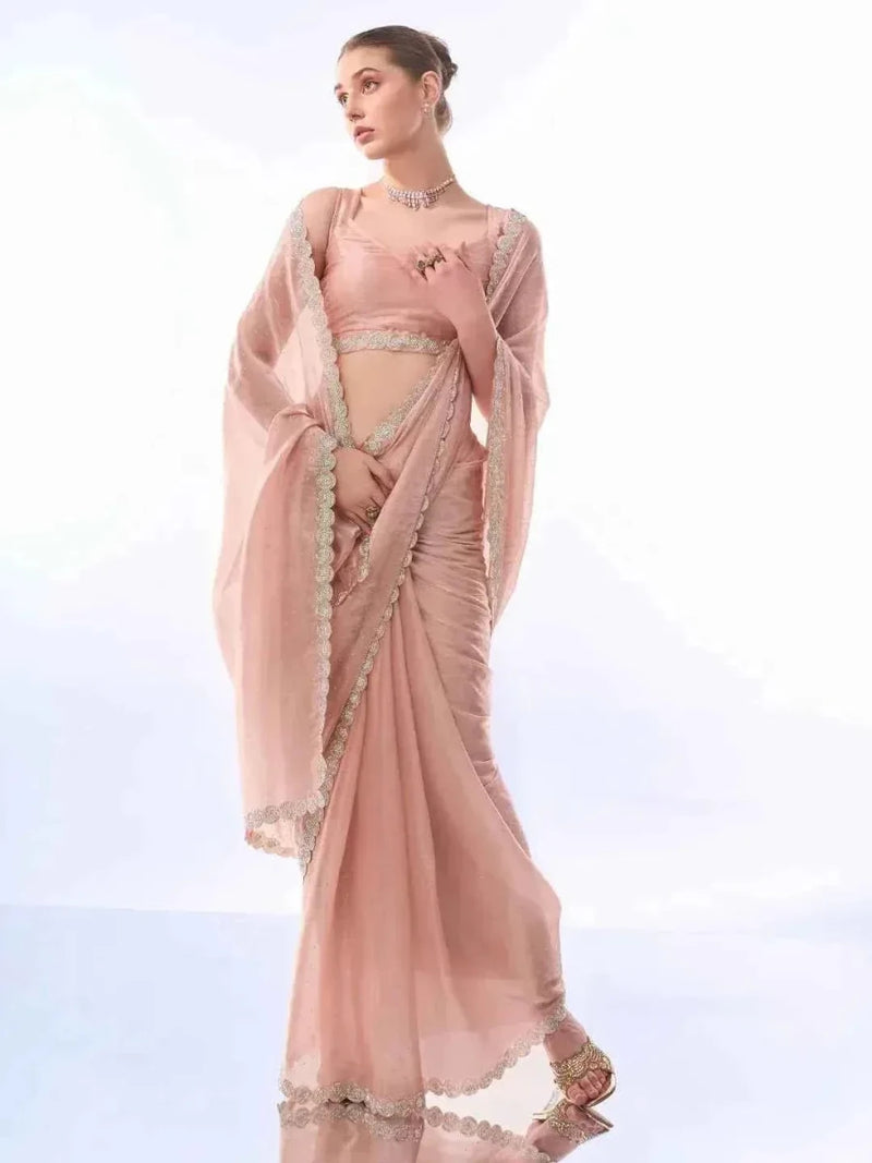 Peach party saree with shimmer embellishments and lace-like border, draped on model