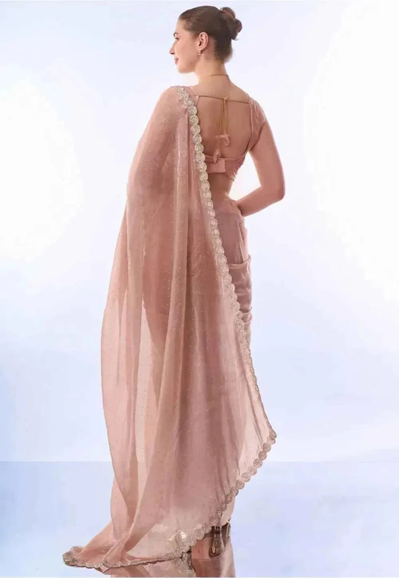 Peach party saree with open back and embellished border along drape