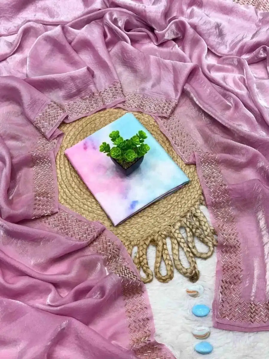 Lavender tissue saree with beaded gold border, tassels, and pouch embellishment.