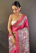 Pink tussar silk saree with printed border and pallu, draped over shoulder