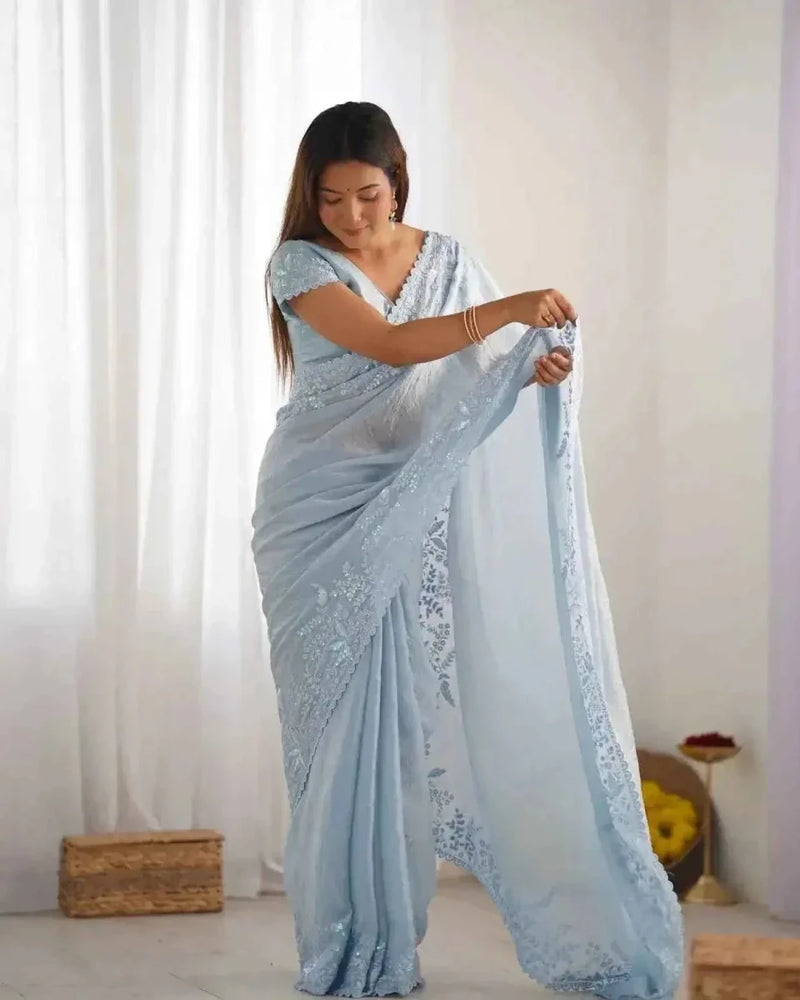 Powder blue crushed tissue saree with silver sequin detailing on the pallu edge