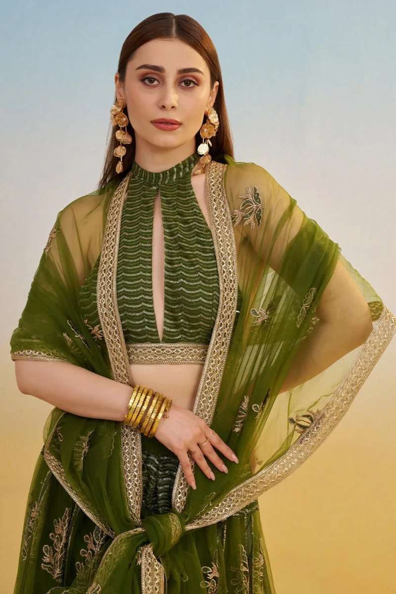 Green embroidered lehenga with sheer dupatta drape and short halter top