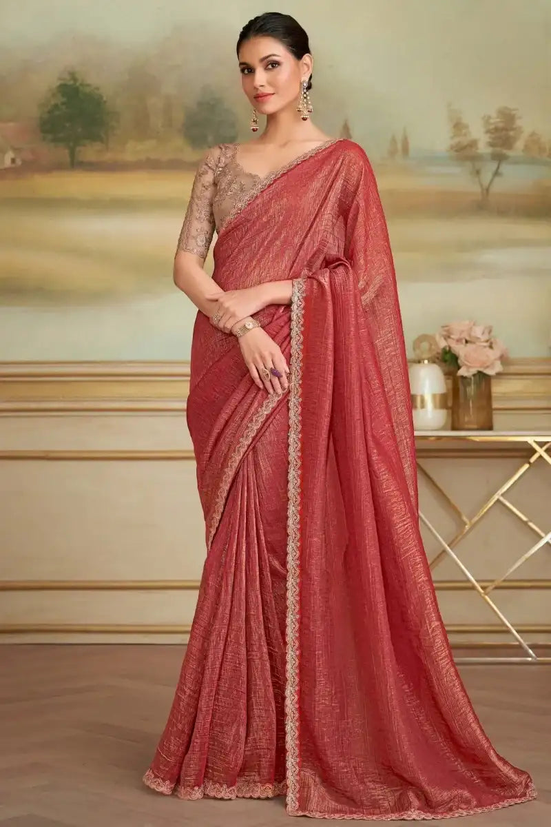 Red embroidered saree with sheer brown blouse and lace-trim border on pallu