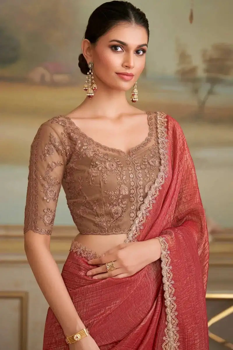 Red saree with sheer brown embroidered blouse, lace trim, and gold-tone accessories