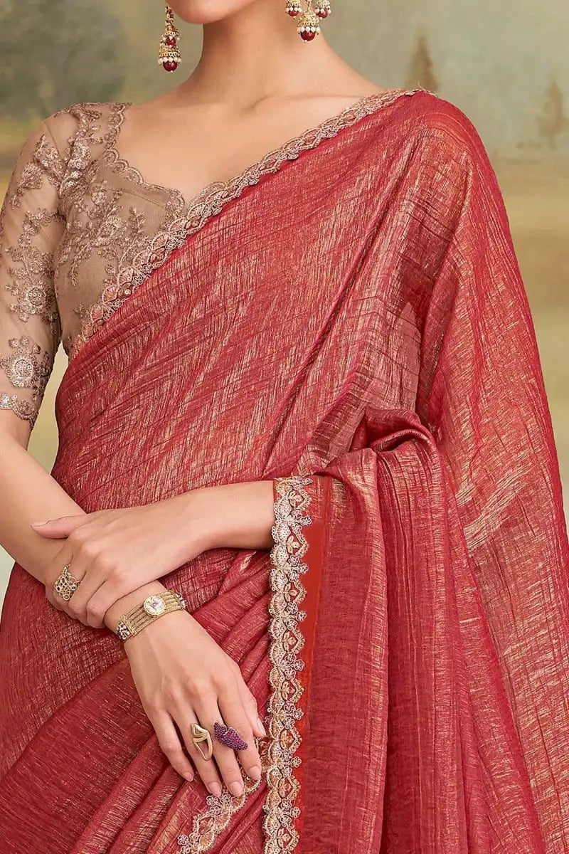 Red embroidered saree drape with cream scalloped border detail and lace-trim pallu