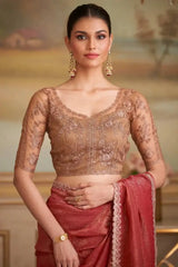 Embroidered red saree with cream lace edging and sheer beige blouse with sleeves
