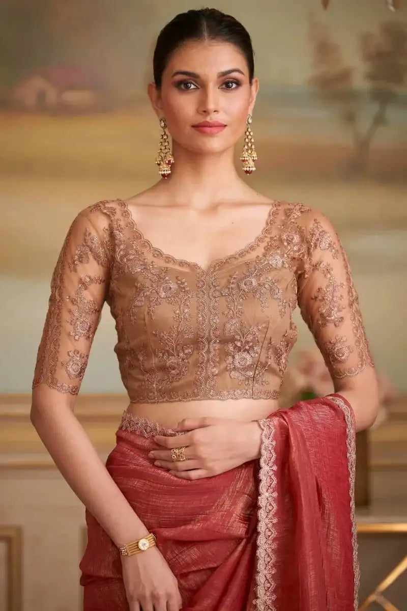 Red saree with sheer brown embroidered blouse and lace-trim hem