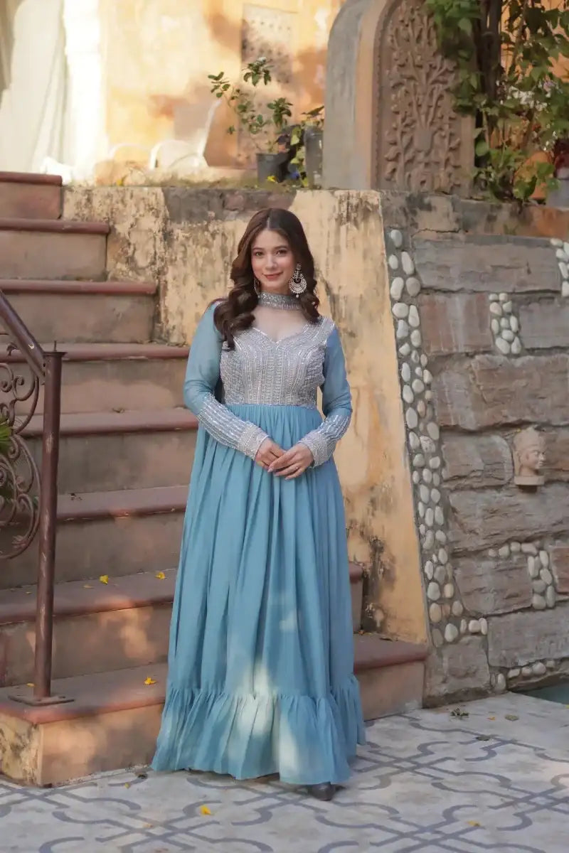 Blue sequined embroidered gown with long sleeves and tiered skirt