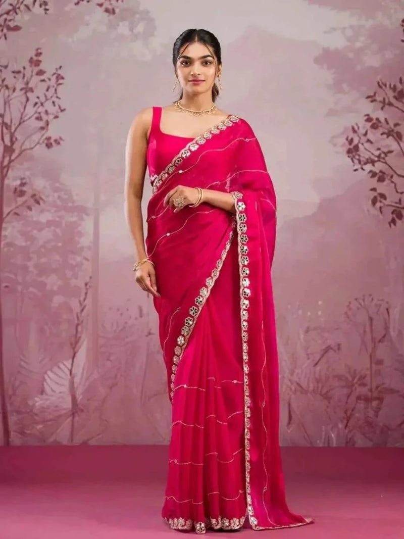 Rani pink saree with silver mirror and dori trim, draped with blouse