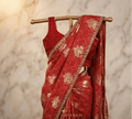Red bandhani georgette saree with gold embroidered border and draped blouse
